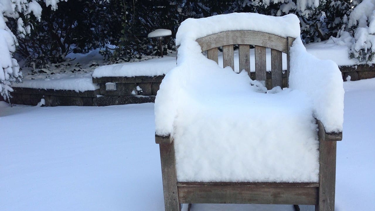 Outdoor chair covered in snow