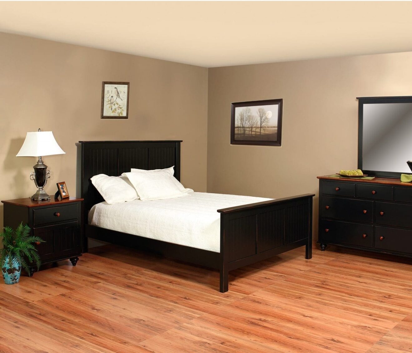 wilkensburg colonial style bedroom setting with bed, nightstand and lamp, and dresser with TV