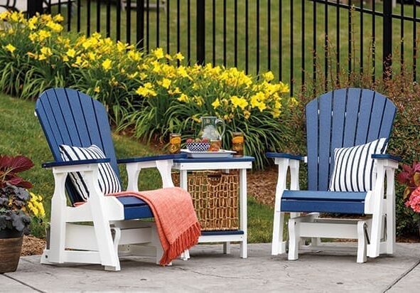 Set of 2 navy blue and white poly furniture glider chairs with a matching end table in the middle.