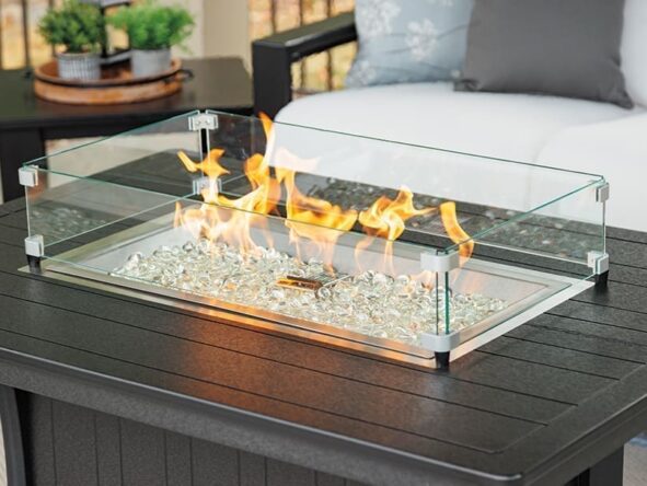 Black poly lumber coffee table with a fire pit and safety glass in the center.