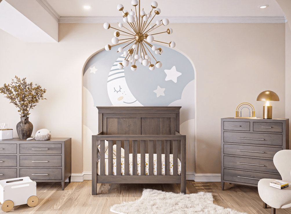 Nursery with 2 light brown hardwood dressers, a light brown hardwood convertible crib with white bedding, beige walls, wood panel floors, and a large painting of a sleeping crescent moon.