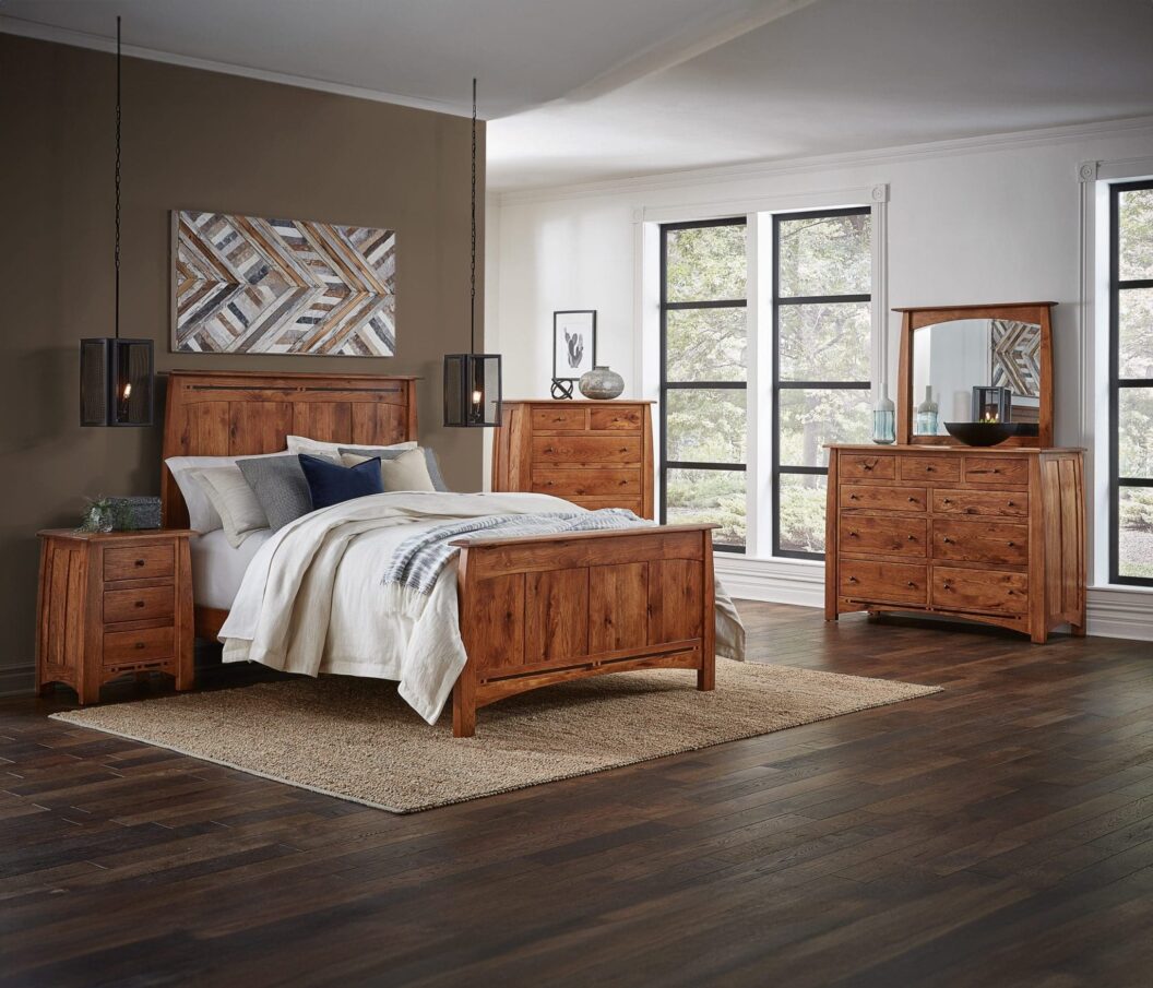 Brown stained hardwood queen bed in a room with matching dressers and a nightstand.