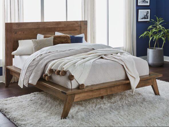 Brown hardwood contemporary style bed with white bedding inside a bedroom with navy blue walls, white curtains, and a large white shag rug.