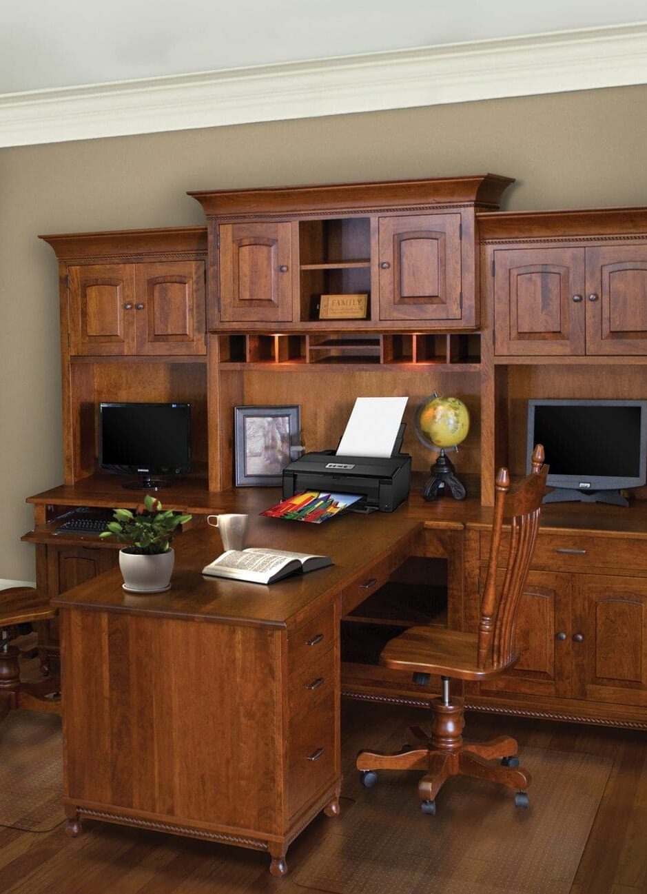 Large desk with a hutch and 2 sides with 2 chairs, 2 computers, a printer, and 2 L shape desks that meet in the middle.
